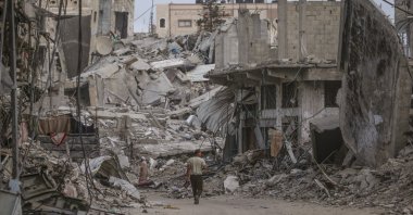 Palestinians walk between rubble of houses before Eid al-Adha prayer in Khan Younis town, southern Gaza Strip, Palestine, June 16, 2024. (EPA Photo)