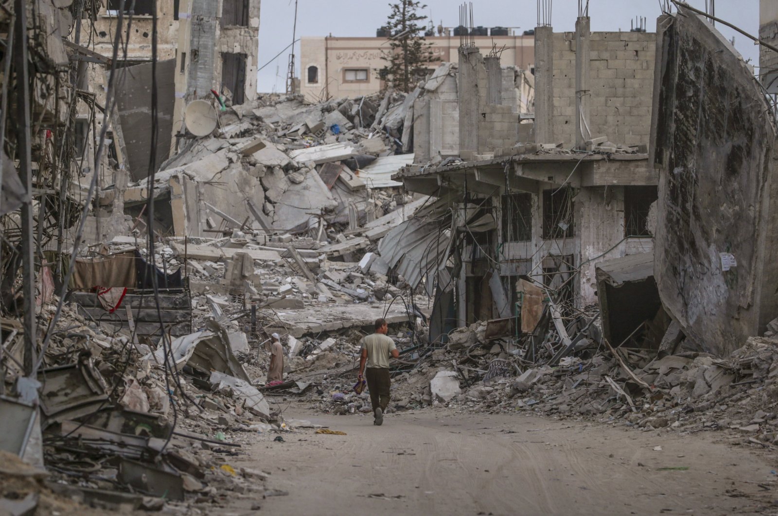 Palestinians walk between rubble of houses before Eid al-Adha prayer in Khan Younis town, southern Gaza Strip, Palestine, June 16, 2024. (EPA Photo)