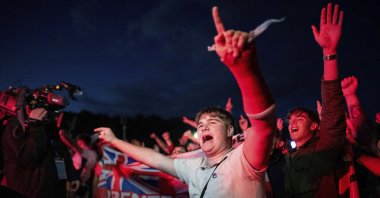 England fans celebrate at the end of a Group C match against Serbia at the Euro 2024 tournament during a public viewing, Gelsenkirchen, Germany, June 16, 2024. (AP Photo)