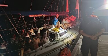 A Turkish coast guard vessel picks up a boat carrying 13  irregular migrants and headed for Italy, off the coast of the Marmaris district in western Muğla province, Türkiye, June 15, 2024. (IHA Photo)