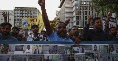 Protesters and survivors shout slogans as they hold a banner with pictures of missing and dead migrants during a rally in remembrance of the Pylos shipwreck one year ago, central Athens, Greece, June 14, 2024. (EPA Photo)