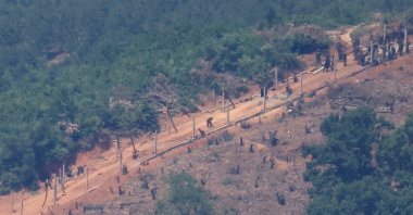 North Korean people work on a military fence near their guard post at the inter-Korean border near the demilitarized zone that separates the two Koreas in Paju, South Korea, June 4, 2024. (Reuters Photo)