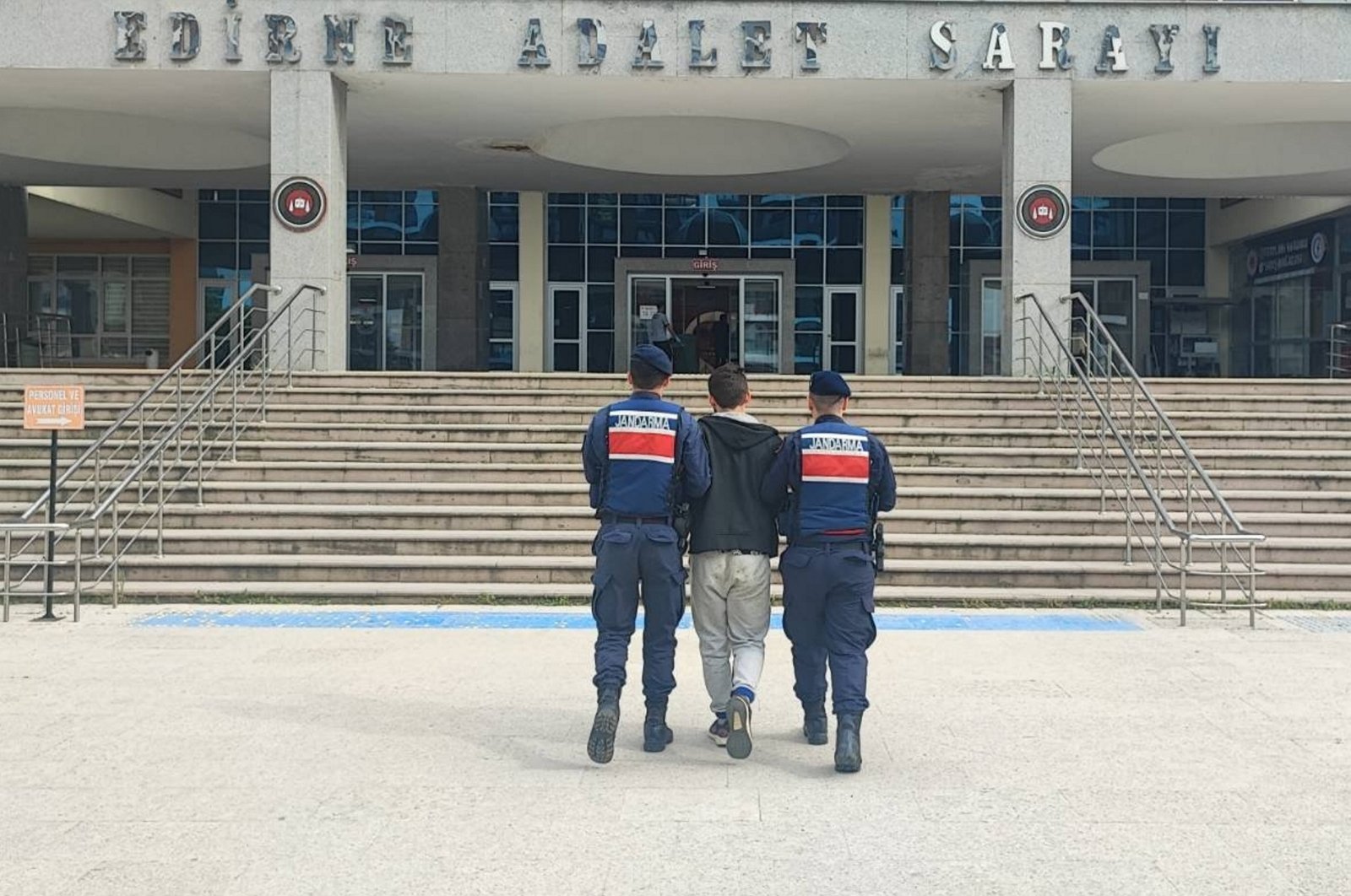 Two gendarmerie officers escort a Gülenist Terror Group (FETÖ) fugitive caught trying to flee abroad, northwestern Edirne province, Türkiye, May 30, 2024. (AA Photto)