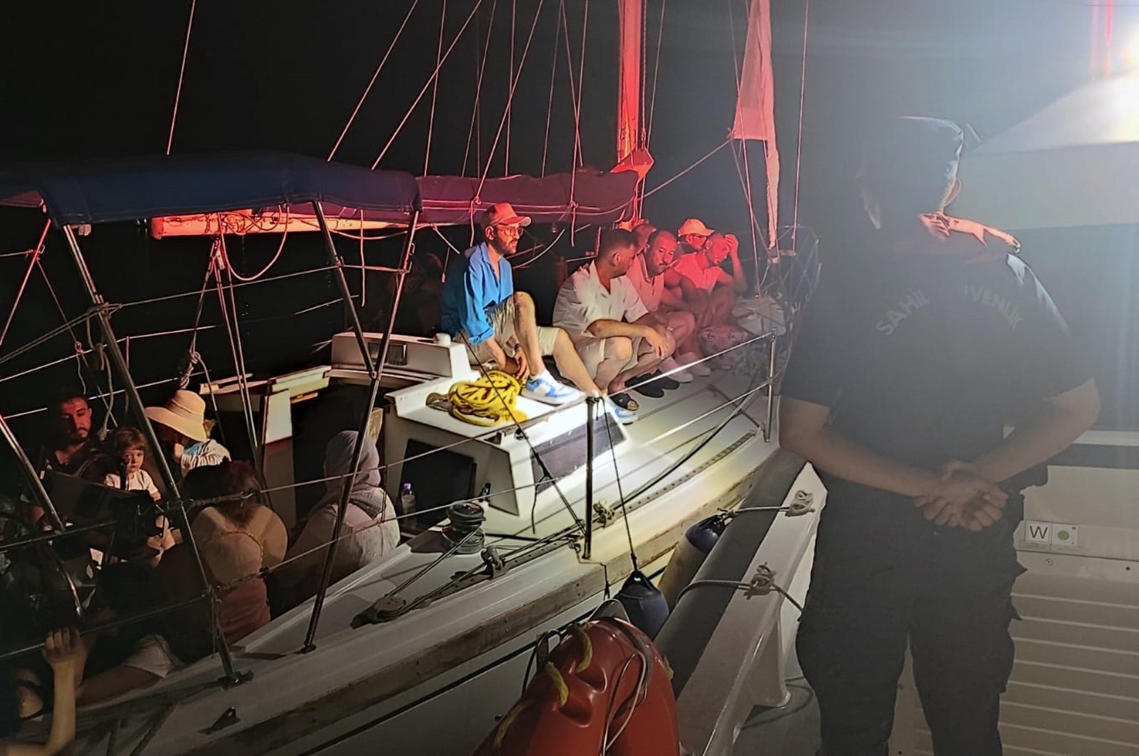 A Turkish coast guard vessel picks up a boat carrying 13  irregular migrants and headed for Italy, off the coast of the Marmaris district in western Muğla province, Türkiye, June 15, 2024. (IHA Photo)