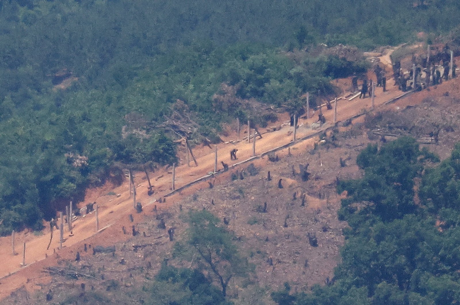 North Korean people work on a military fence near their guard post at the inter-Korean border near the demilitarized zone that separates the two Koreas in Paju, South Korea, June 4, 2024. (Reuters Photo)