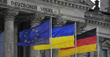 The European Union (EU), Ukrainian and German flags flutter in front of the Reichstag building housing the Bundestag (lower house of parliament) in Berlin, Germany, June 11, 2024. (AFP Photo)