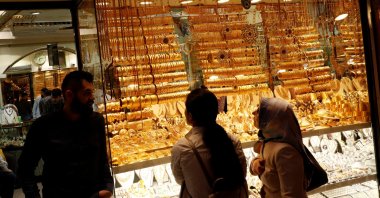 Women look at gold jewelry at a shop in Istanbul, Türkiye, May 9, 2019. (Reuters Photo)