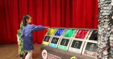 A worker sweeps paper for recycling into a sorter, Istanbul, Türkiye, June 19, 2024. (DHA Photo)