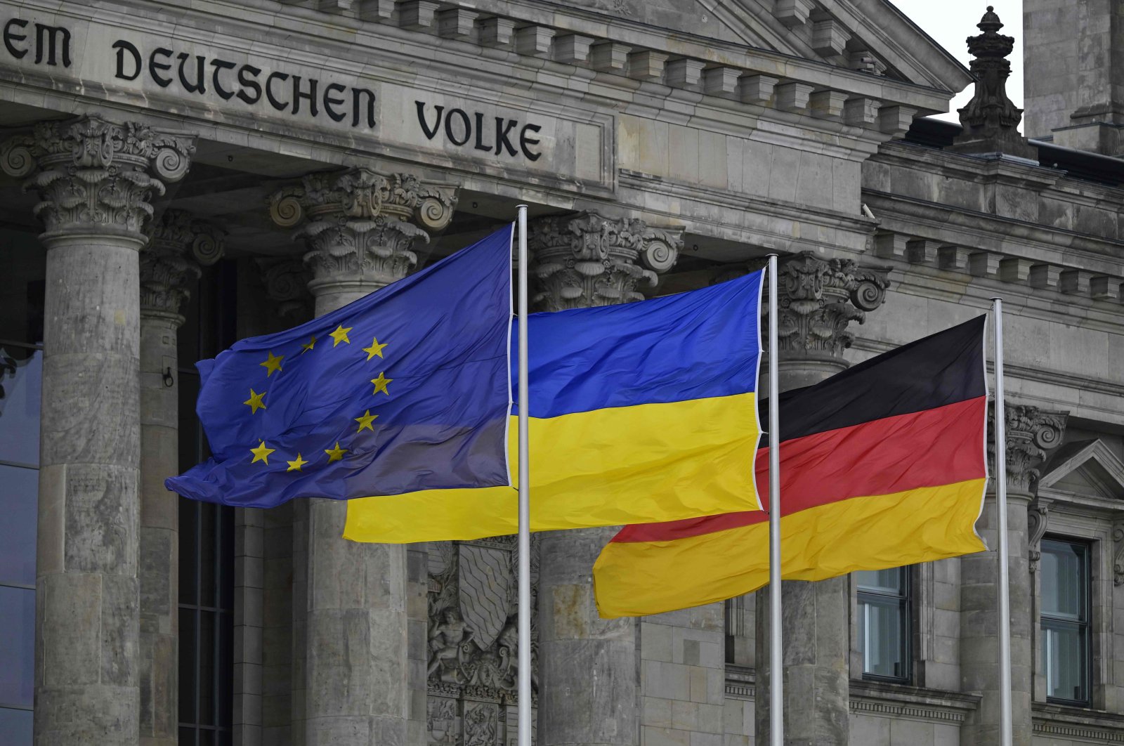 The European Union (EU), Ukrainian and German flags flutter in front of the Reichstag building housing the Bundestag (lower house of parliament) in Berlin, Germany, June 11, 2024. (AFP Photo)