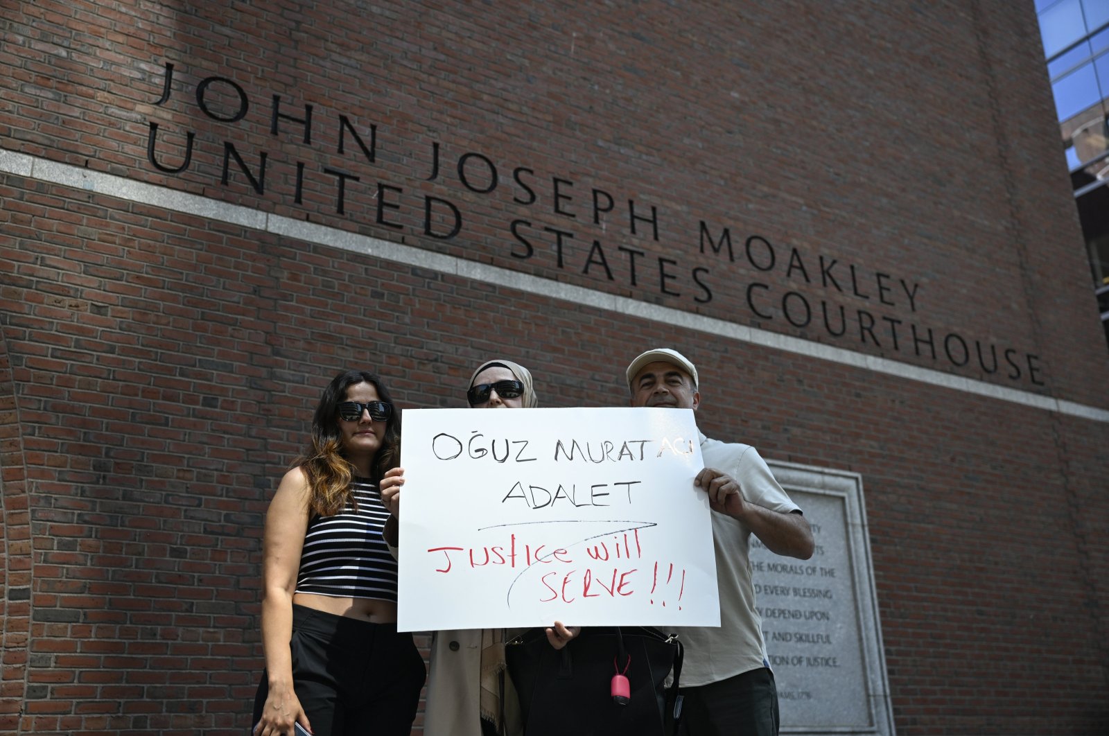 Members of the Turkish diaspora hold a placard demanding justice for the death of Oğuz Murat Aci in a hit-and-run involving Timur Cihantimur as Cihantimur&#039;s hearing proceeds at a courthouse, Boston, Massachusetts, U.S., June 18, 2024. (AA Photo)