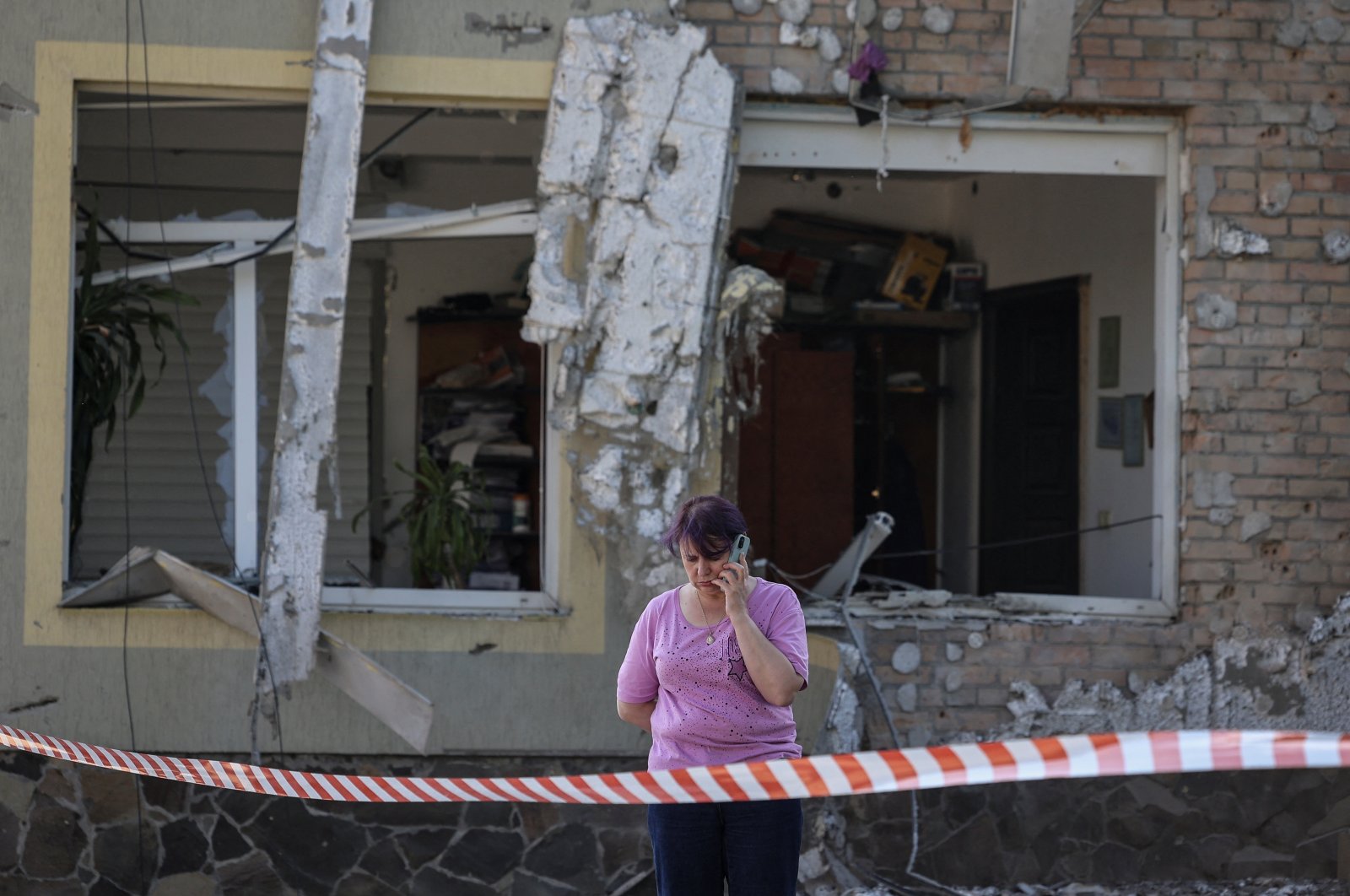 A local woman speaks on her mobile phone at the site of a Russian drone attack, amid Russia&#039;s attack on Ukraine, on the outskirts of Lviv, Ukraine, June 19, 2024. (Reuters Photo)