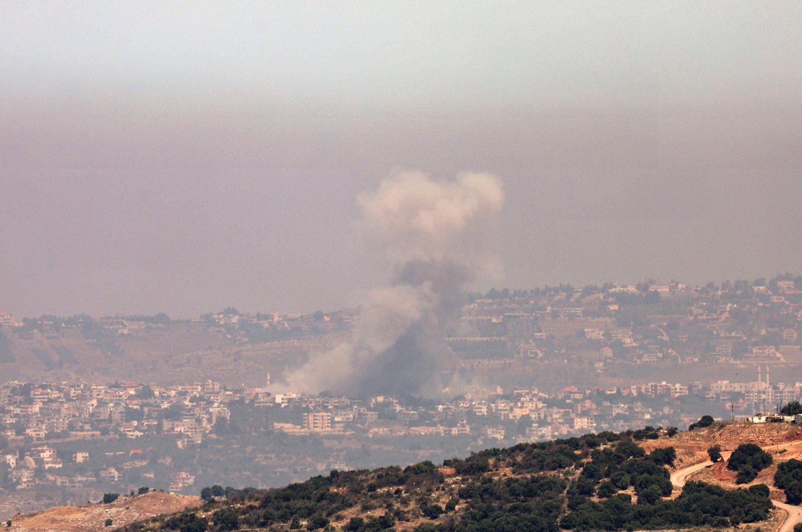 Smoke rises as a result of an Israeli airstrike in the southern Lebanese town of Khiam, as seen from northern Israel, June 19, 2024. (EPA Photo)