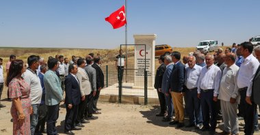 Citizens stand in silence to honor Neşe Alten, a teacher killed at 21 in a PKK attack 31 years ago, as they inaugurate a memorial for her, in Bismil district of southeastern Diyarbakır, Türkiye, June 14, 2024. (AA Photo)
