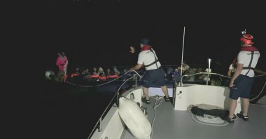 A Turkish coast guard vessel picks up a rubber boat carrying 37 irregular migrants, including two children, off the coast of Çeşme district in Izmir province, Türkiye, June 19, 2024. (AA Photo)