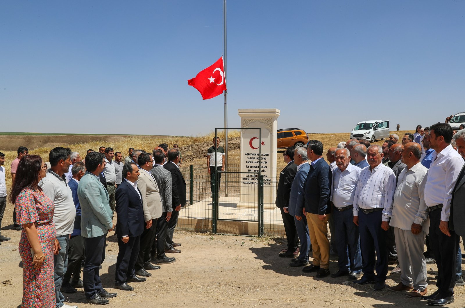 Citizens stand in silence to honor Neşe Alten, a teacher killed at 21 in a PKK attack 31 years ago, as they inaugurate a memorial for her, in Bismil district of southeastern Diyarbakır, Türkiye, June 14, 2024. (AA Photo)
