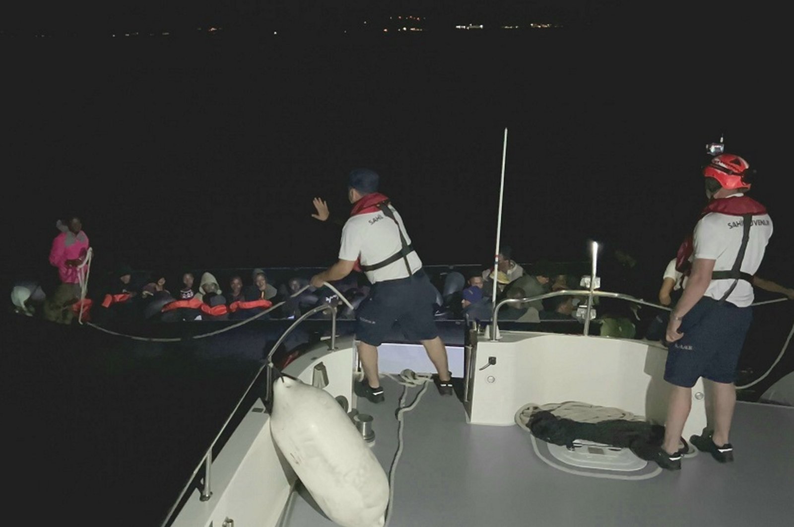 A Turkish coast guard vessel picks up a rubber boat carrying 37 irregular migrants, including two children, off the coast of Çeşme district in Izmir province, Türkiye, June 19, 2024. (AA Photo)