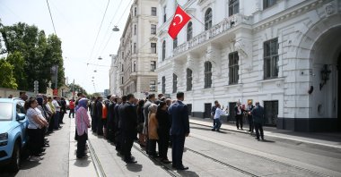 Attendees stand in silence as they hold a commemoration ceremony for Erdoğan Özen, killed by the ASALA terrorist group in 1984, outside the Turkish Embassy in Vienna, Austria, on June 20, 2024. (AA Photo)