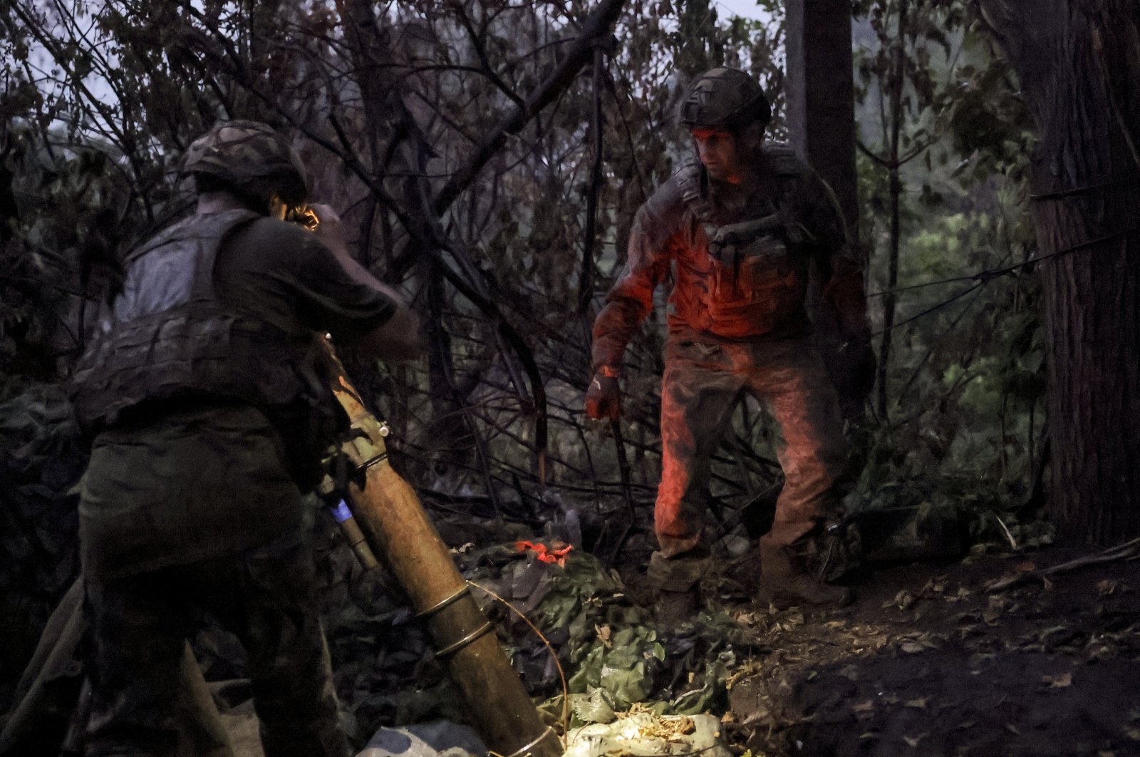 Ukrainian servicemen of the 24th Mechanized Brigade named after King Danylo operating a 120 mm mortar at an undisclosed location near the front line city of Chasiv Yar, Donetsk, Ukraine, June 20, 2024. (Ukrainian army handout via EPA Photo)