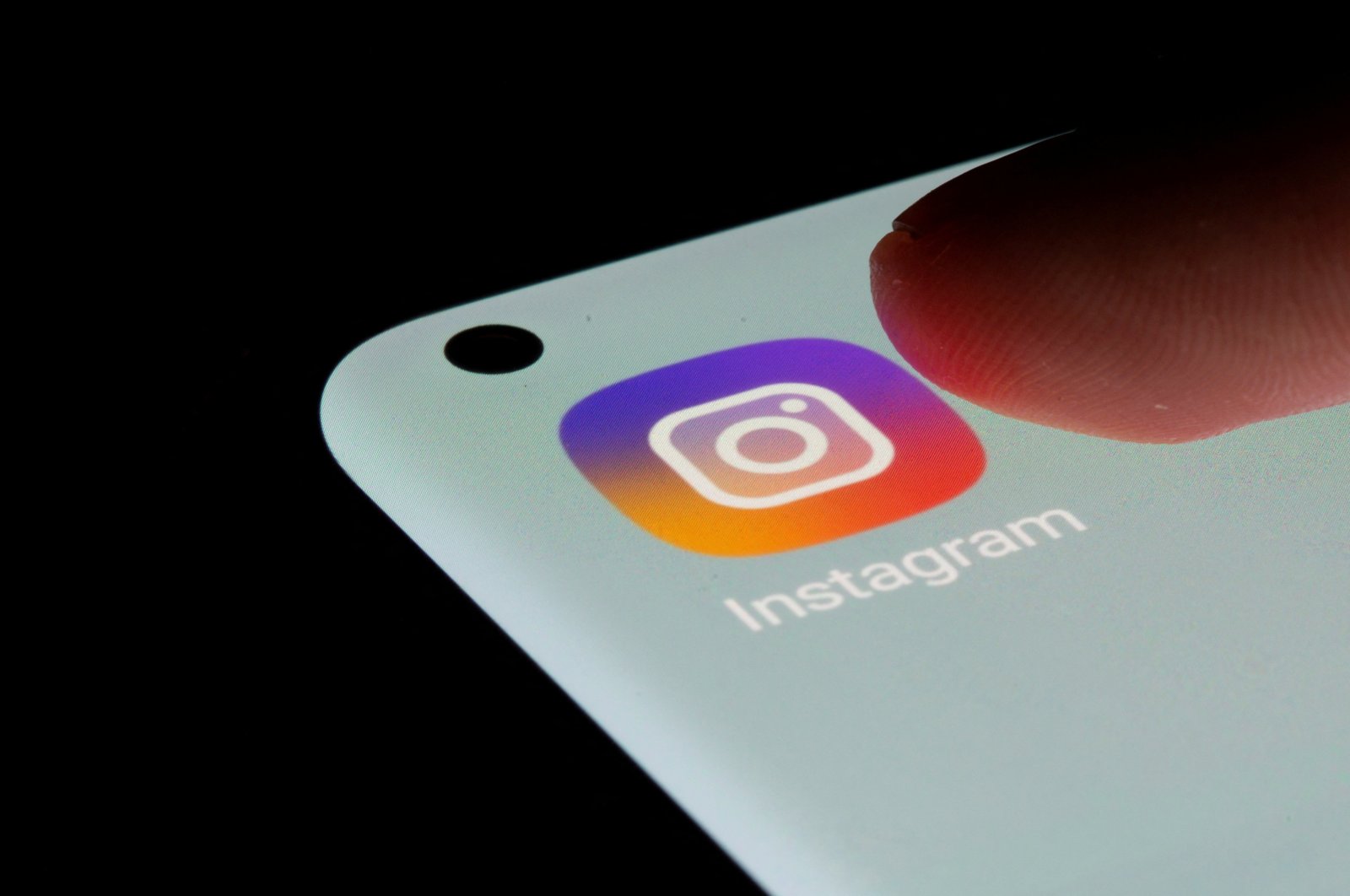 An Instagram app icon is seen on a smartphone in this illustration taken on July 13, 2021. (Reuters Photo)