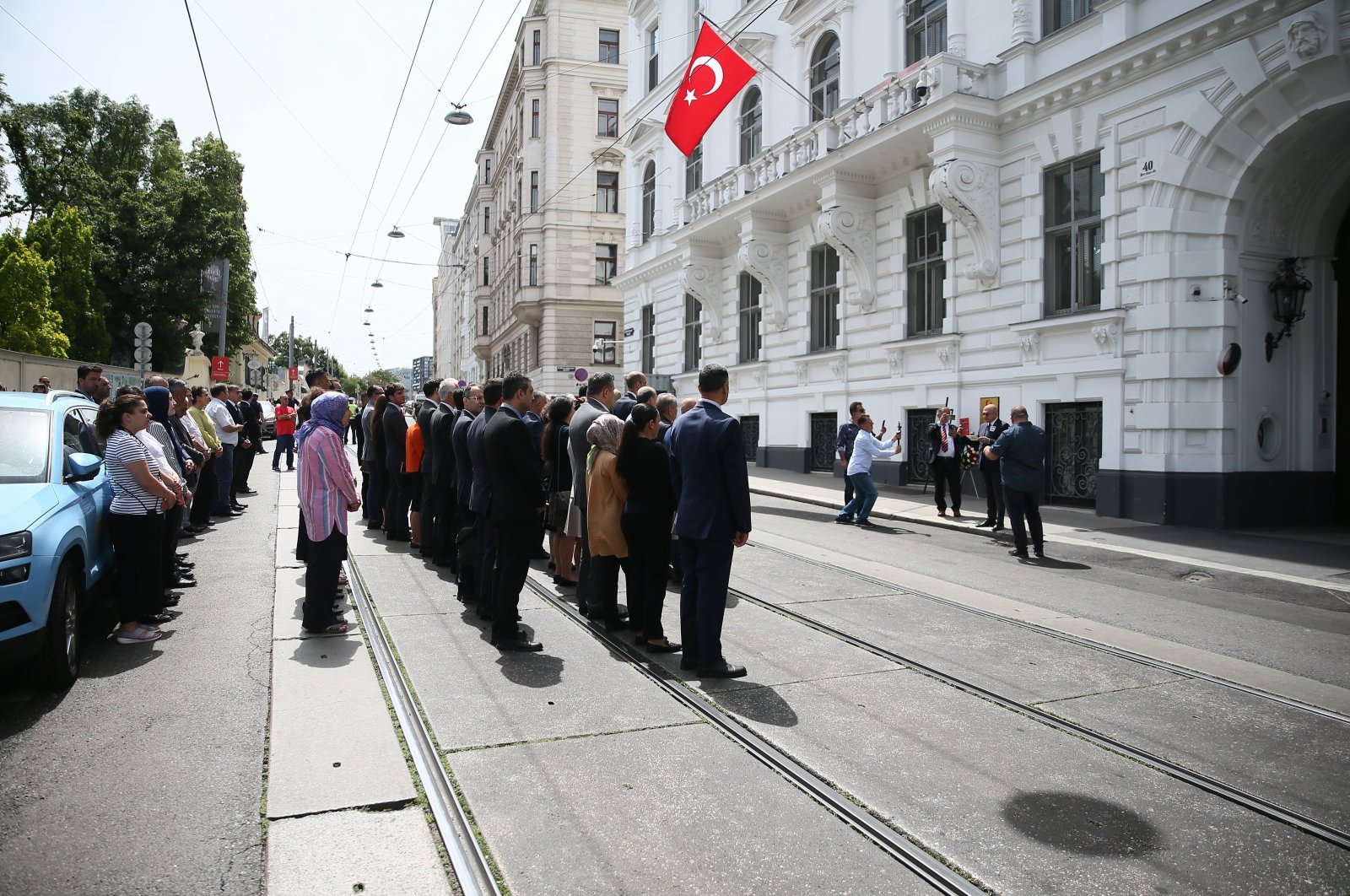 Attendees stand in silence as they hold a commemoration ceremony for Erdoğan Özen, killed by the ASALA terrorist group in 1984, outside the Turkish Embassy in Vienna, Austria, on June 20, 2024. (AA Photo)