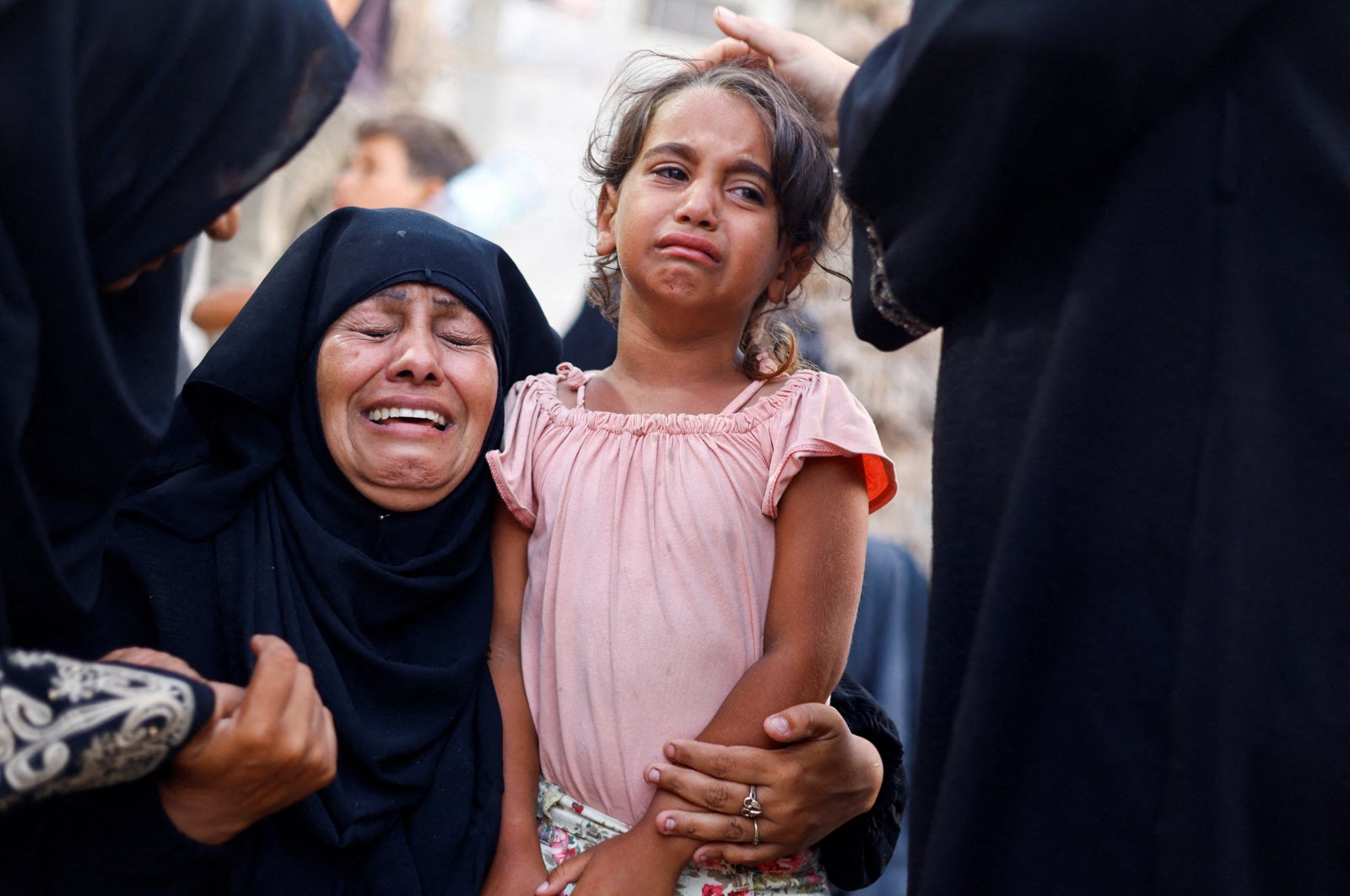 A woman and a girl react following an Israeli strike that hit a tent camp, in Al-Mawasi area in western Rafah, in the southern Gaza Strip, June 21, 2024. (Reuters Photo)