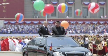 Russian President Vladimir Putin (C-L) and North Korea&#039;s leader Kim Jong Un (C-R) ride on an open car, as they parade during the official welcome ceremony at the Kim Il Sung Square in Pyongyang, North Korea, June 19, 2024. (AP Photo)