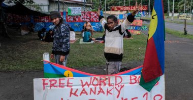 Protesters stand on an encampment set up in the Riviere Salee district of Noumea, New Caledonia, June 12, 2024. (AFP Photo)
