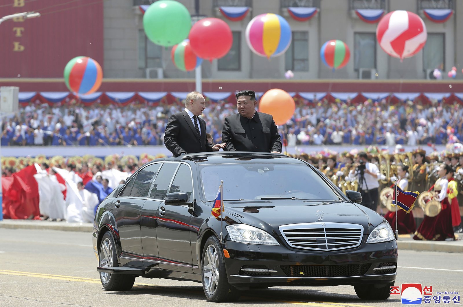 Russian President Vladimir Putin (C-L) and North Korea&#039;s leader Kim Jong Un (C-R) ride on an open car, as they parade during the official welcome ceremony at the Kim Il Sung Square in Pyongyang, North Korea, June 19, 2024. (AP Photo)