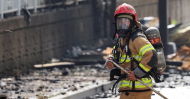 A firefighter works at the site of a deadly fire at a lithium battery factory in Hwaseong, South Korea, June 24, 2024. (Reuters Photo)