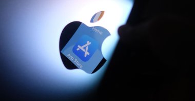 This illustration photo shows the Apple app store logo reflected from an iPhone onto the back of an iMac, Los Angeles, U.S., Aug. 26, 2021. (AFP Photo)