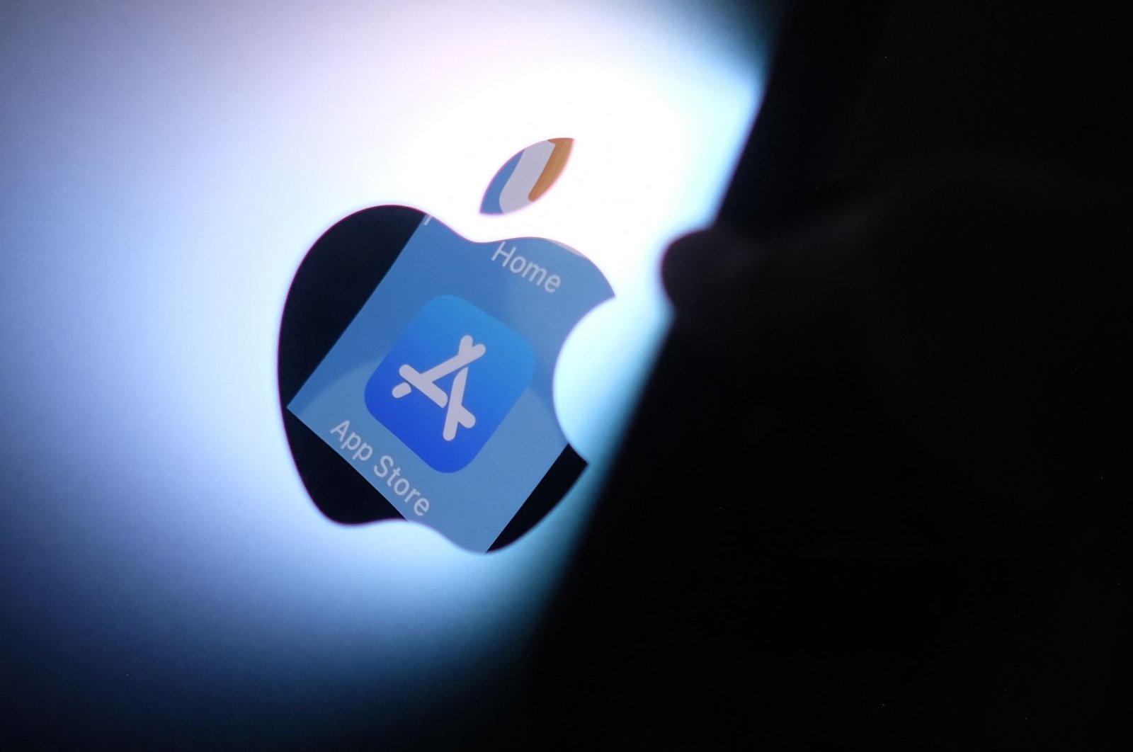 This illustration photo shows the Apple app store logo reflected from an iPhone onto the back of an iMac, Los Angeles, U.S., Aug. 26, 2021. (AFP Photo)