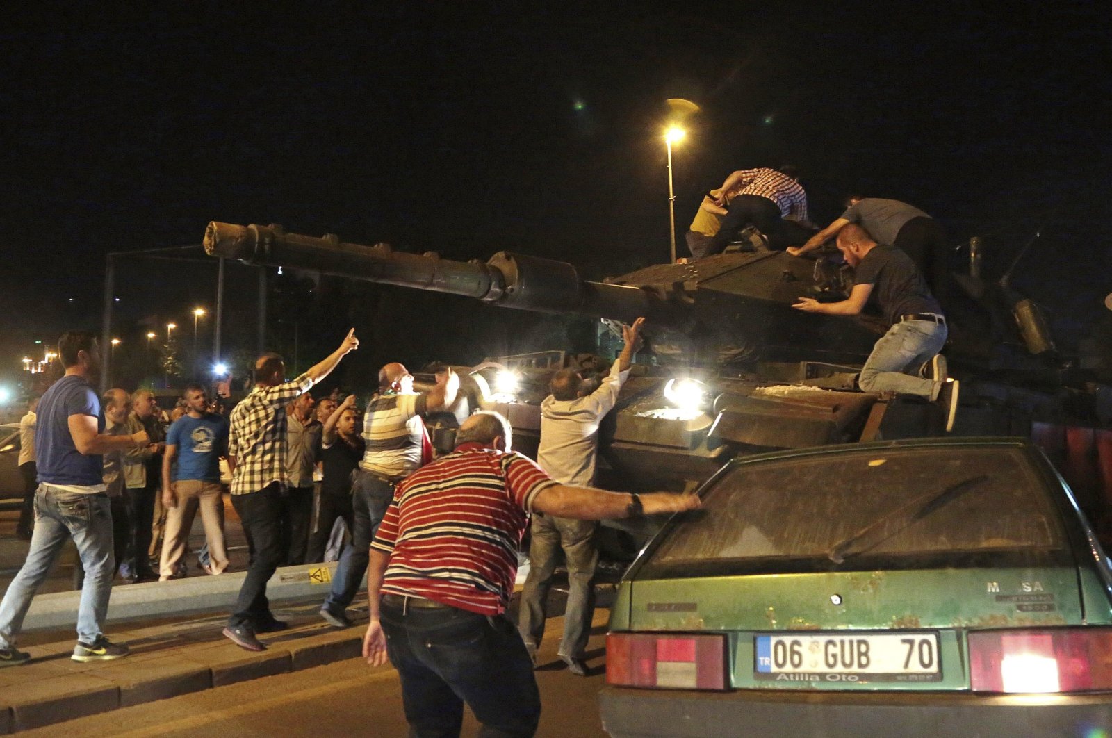 Civilians try to stop putschist troops in a tank during the coup attempt, Ankara, Türkiye, July 15, 2016. (AP Photo)