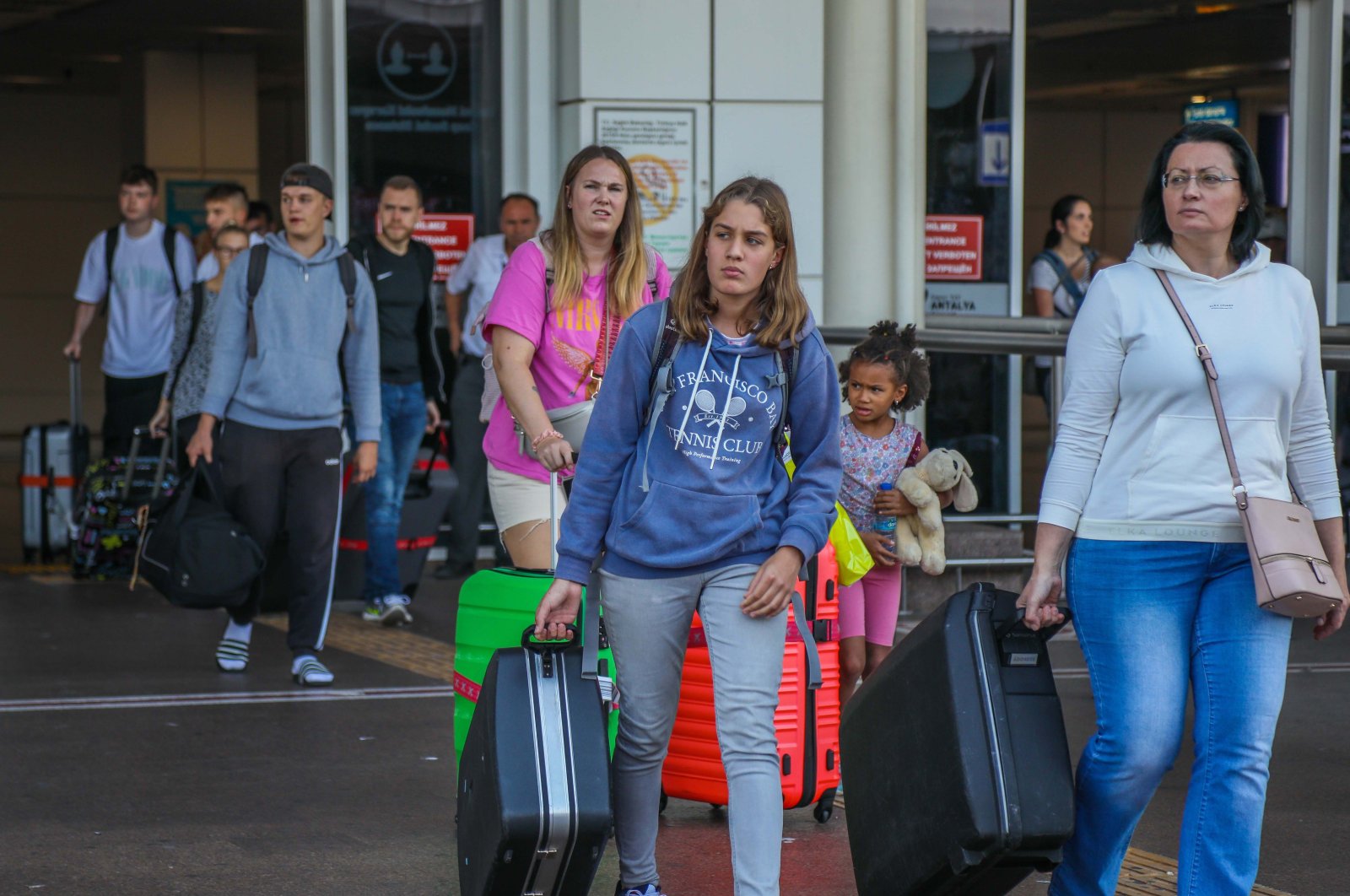 Passengers exit the airport as they arrive in the Mediterranean tourism hot spot Antalya, southern Türkiye, Sept. 22, 2022. (DHA Photo)