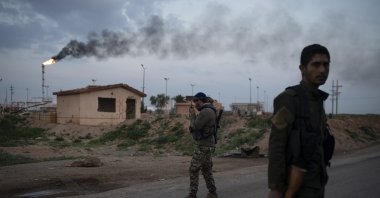 PKK/YPG members wait at a checkpoint near Omar oil field base, eastern Syria, Feb. 24, 2019. (AP Photo)
