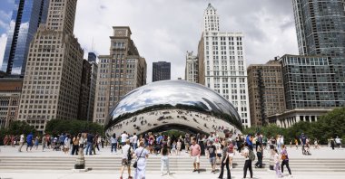Visitors take photos of the &quot;Cloud Gate&quot; sculpture, also known as the &quot;Bean,&quot; at Millennium Park, Chicago, U.S., June 23, 2024. (AP Photo)
