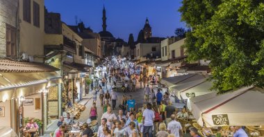 Tourists are photographed in Sokratus Street of Rhodes island in this undated photo, Greece. (Getty Images Photo)