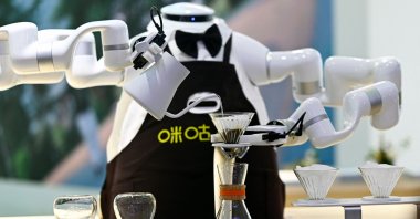 A robot makes coffee during the World Intelligence Expo, Tianjin, China, June 23, 2024. (AFP Photo)