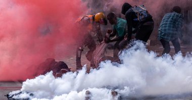 Protesters try to help injured people outside the Kenyan parliament during a nationwide protest against tax hikes, Nairobi, Kenya, June 25, 2024. (AFP Photo)