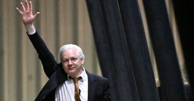 WikiLeaks founder Julian Assange waves after arriving at Canberra Airport in Canberra, Australia, June 26, 2024. (AFP Photo)