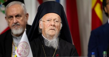 The "Ecumenical Patriarchate" sign is prominently displayed in front of Patriarch Bartholomew I as he attends the summit, Stansstad, Switzerland, June 16, 2024. (EPA Photo)