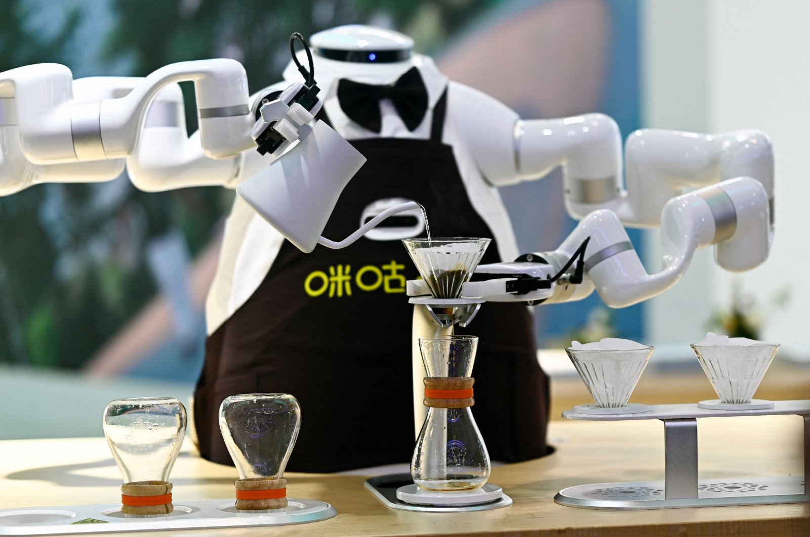 A robot makes coffee during the World Intelligence Expo, Tianjin, China, June 23, 2024. (AFP Photo)