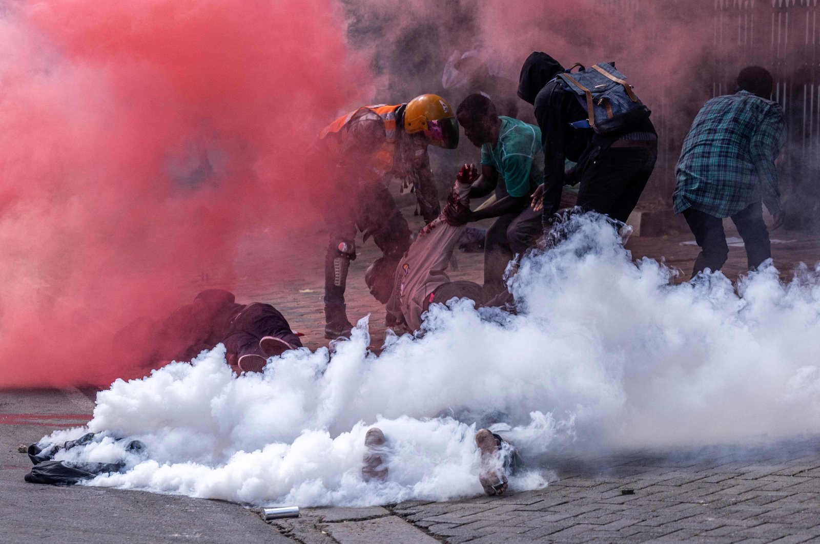 Protesters try to help injured people outside the Kenyan parliament during a nationwide protest against tax hikes, Nairobi, Kenya, June 25, 2024. (AFP Photo)