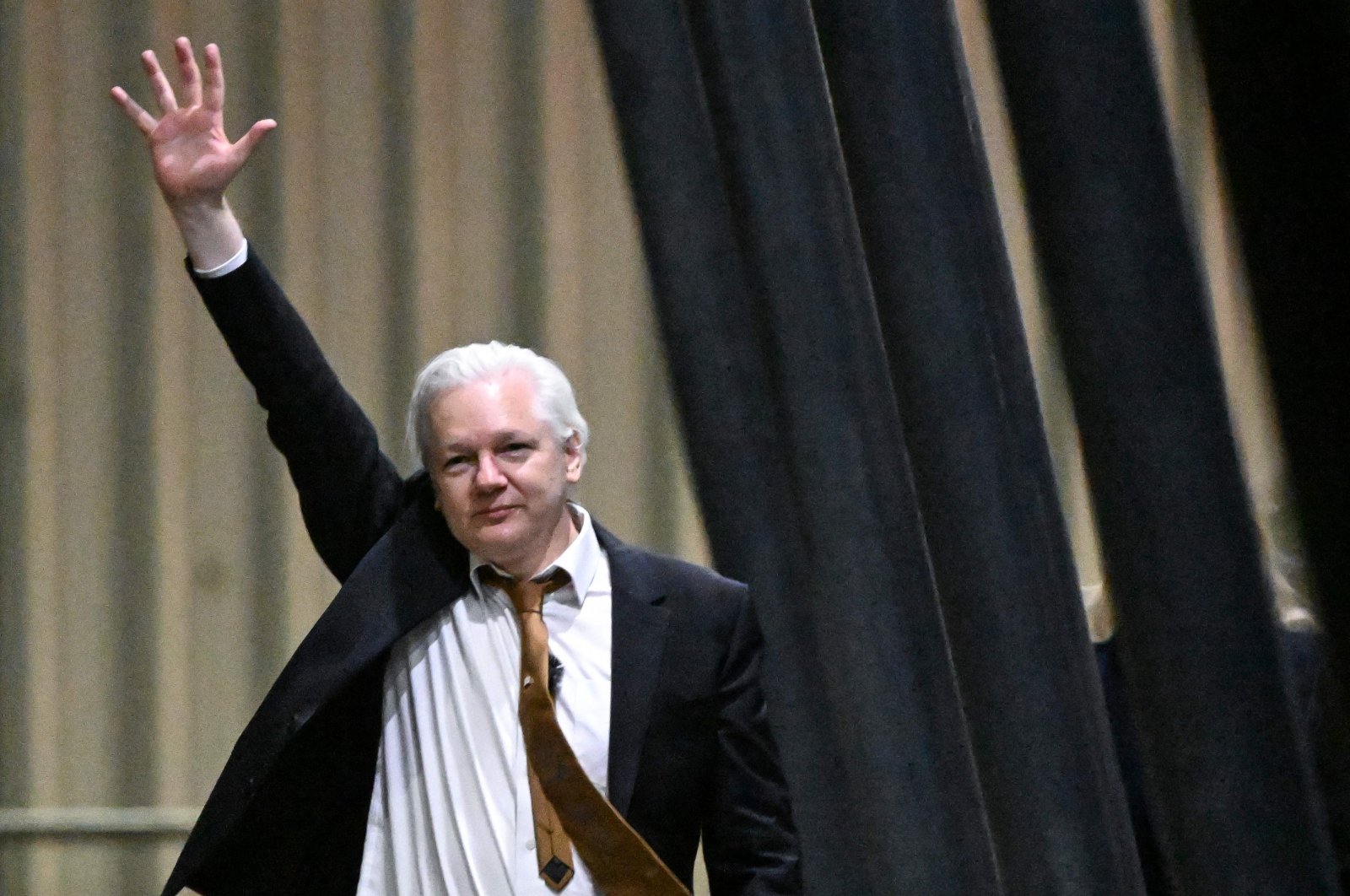 WikiLeaks founder Julian Assange waves after arriving at Canberra Airport in Canberra, Australia, June 26, 2024. (AFP Photo)