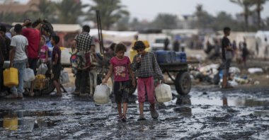 Palestinian kids sort through trash at a landfill in Nuseirat refugee camp, Gaza Strip, June 20, 2024. (AP Photo)