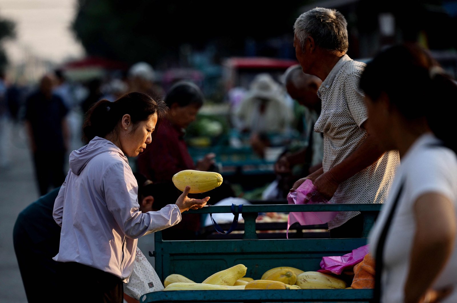 Customers select vegetables at a market in Heze, in eastern Shandong province, China, June 12, 2024. (AFP Photo)