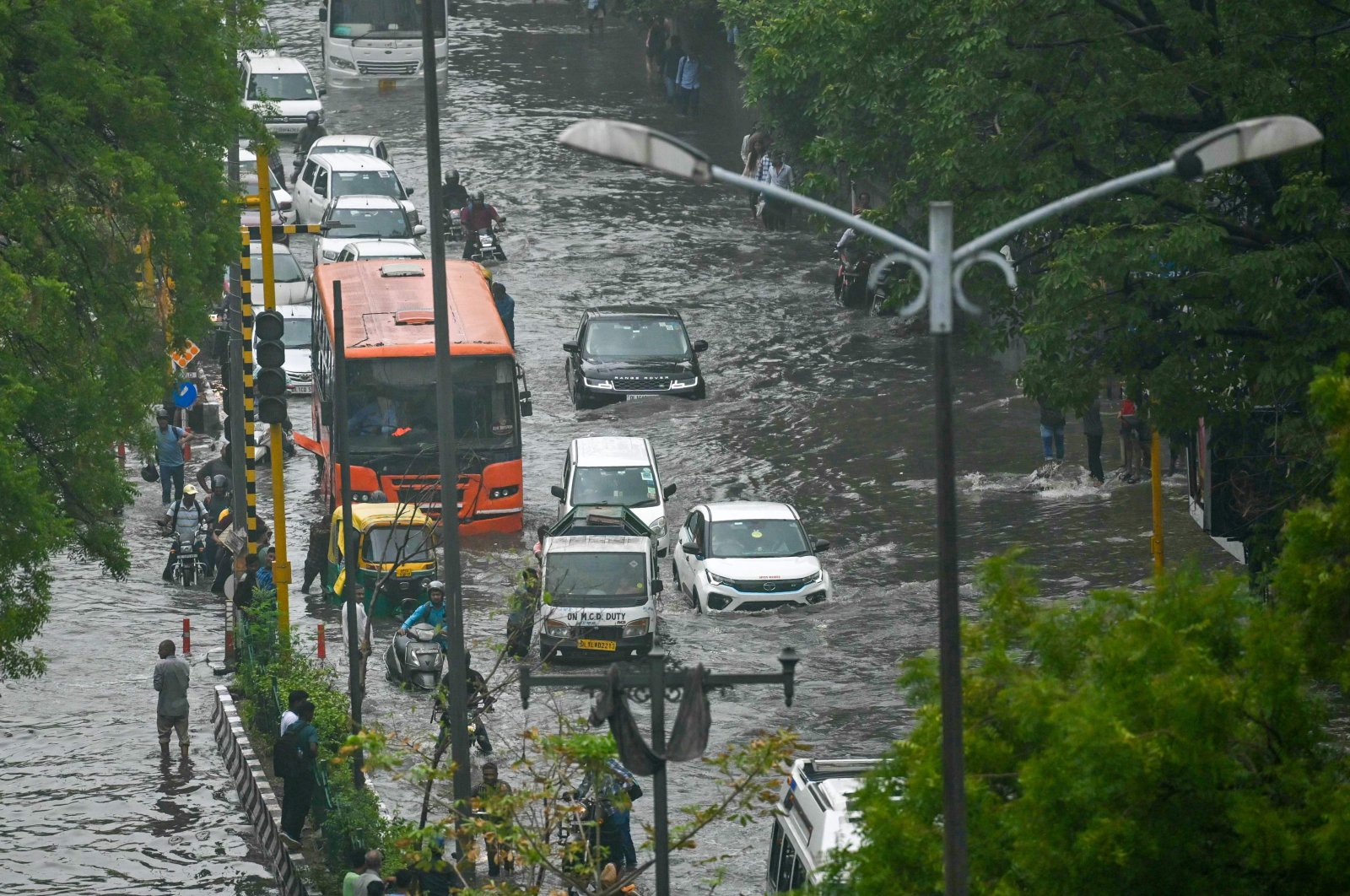 Vehicles wade through flooded streets after heavy rains, New Delhi, India, June 28, 2024. (AFP Photo)