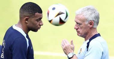 France&#039;s Kylian Mbappe (L) speaks with coach Didier Deschamps during training in Paderborn, Germany, June 27, 2024. (AFP Photo)