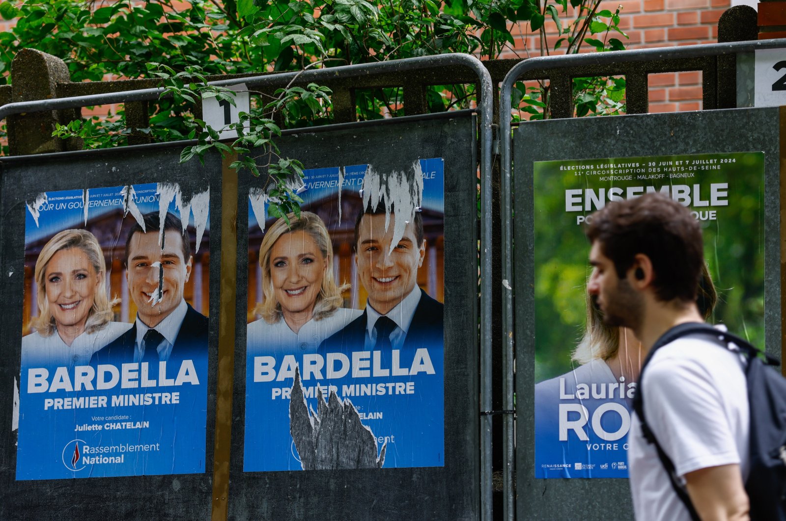 Legislative election posters on billboards, including French member of parliament and previous candidate for French presidential election Marine Le Pen (L) and leader of the French extreme right party Rassemblement National (RN, National Front) Jordan Bardella (R), are displayed outside of polling station in Malakoff, near Paris, France, June 29, 2024. (EPA Photo)