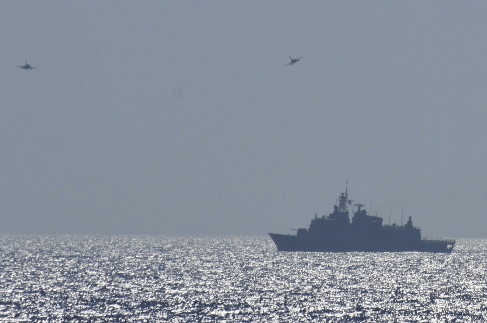 In this photo provided by the Greek Defense Ministry, air force jets and a warship take part in a military exercise in Eastern Mediterranean sea, Aug. 25, 2020. (AP Photo)