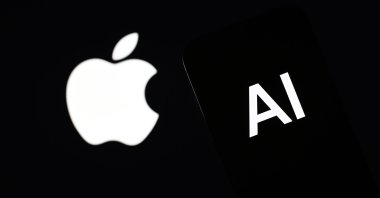 The Apple logo is displayed alongside an AI logo on a smartphone screen in this photo illustration, June 10, 2024. (AA Photo)